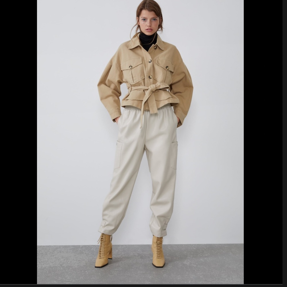 NWT cream faux leather cargo pants. elastic waist & silver button details.